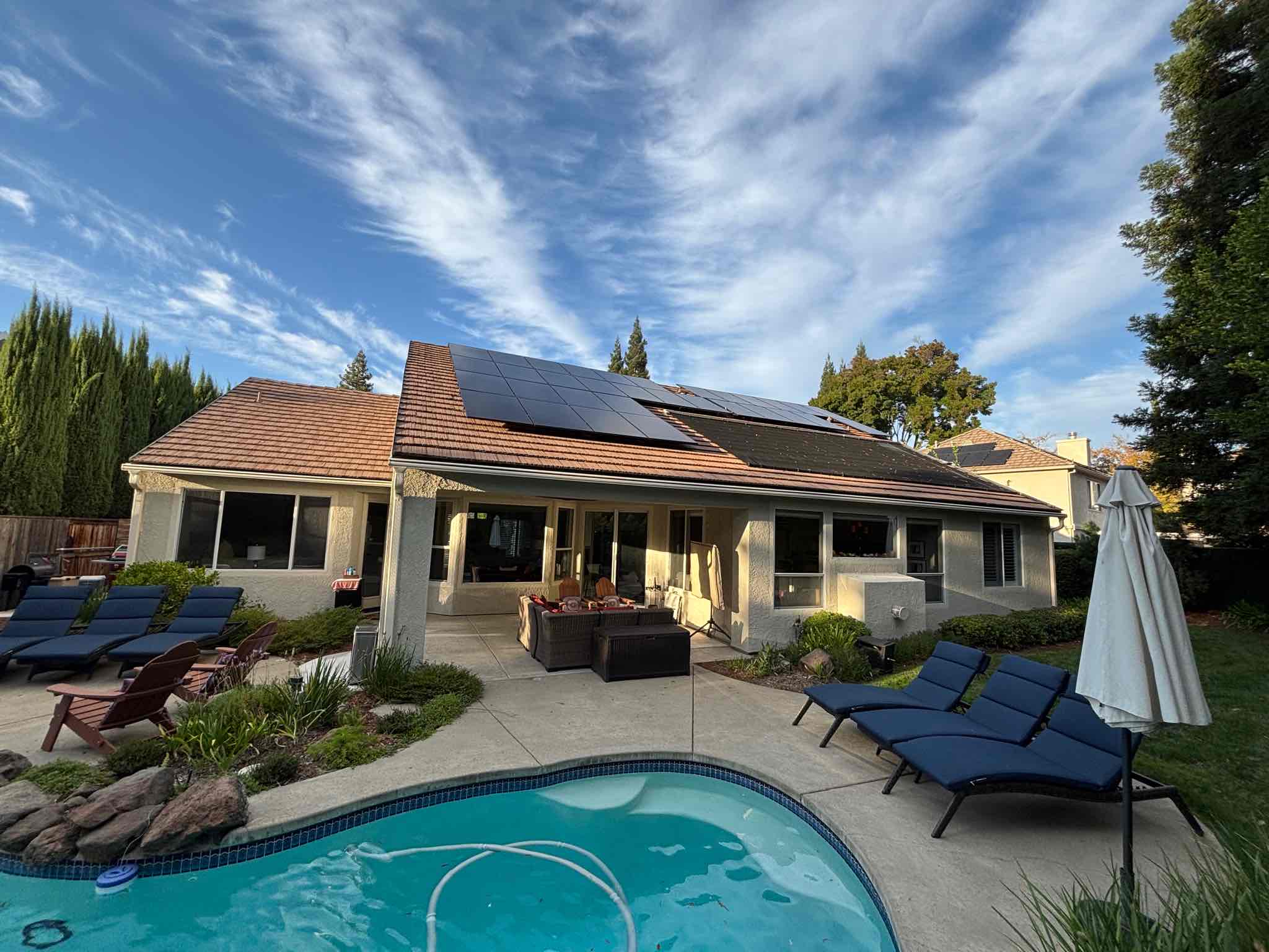 A Northern California house with a full rooftop solar array under a clear sky